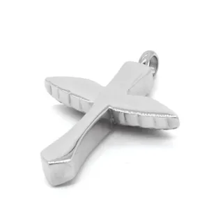 Close-up side view of a vintage stainless steel wing-shaped cross urn pendant for ashes