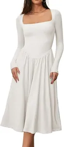 Detailed view of a white long-sleeve dress featuring a square neckline and pleated skirt