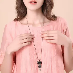Elegant long sweater necklace featuring a cute cat crystal pendant for stylish women