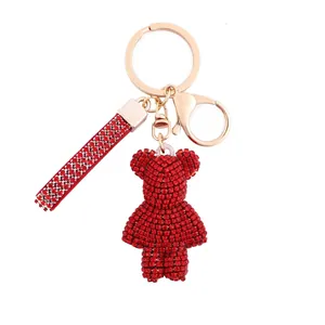 Red rhinestone teddy bear keychain with matching strap and gold metal hardware