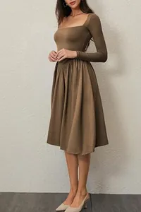 Detail showing the square neck and pleated skirt of this brown long sleeve midi dress.