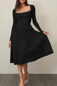 Detail of black square neck long sleeve pleated dress for women, showing fabric texture.
