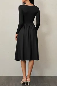 Back view of an elegant black long-sleeve dress featuring a square neck and pleated skirt.