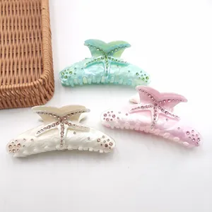 Set of three marble acetate starfish hair claw clips with sparkling rhinestones.