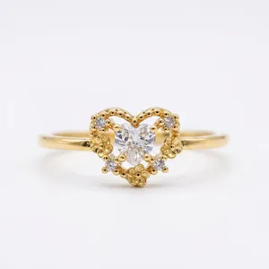 Close-up of heart-shaped 18K gold plated ring with micro-set sparkling zircons