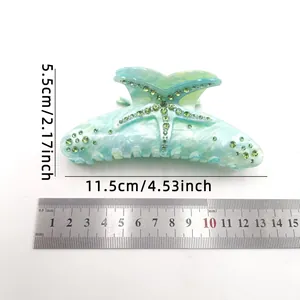 Large acetate starfish hair claw clip with rhinestones shown with measurement ruler