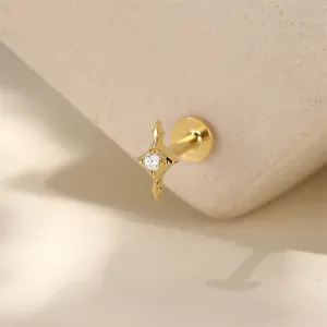 Detailed macro view of a gold-plated star-shaped stud earring with zirconia stone