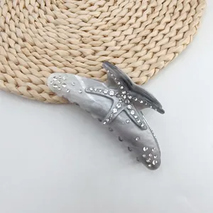 Close-up of starfish hair claw clip with rhinestones and grey marble acetate finish