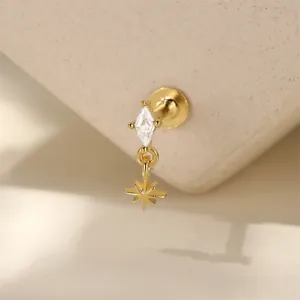 Detailed close-up of golden S925 silver labret stud with diamond zircon and eight-pointed star
