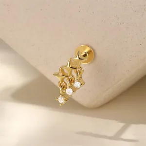 Macro detail view of gold S925 sterling silver star earring with dangling diamond tassels