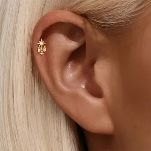 Detailed view of a gold S925 sterling silver starburst earring with zircon stone fringes