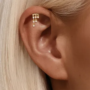 Detail view of a gold-plated sterling silver tassel cartilage stud with cubic zirconia.