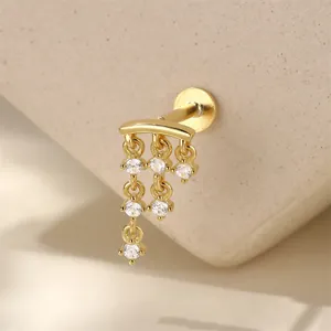 Close-up of gold-plated sterling silver tassel labret stud with cubic zirconia stones