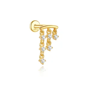 Macro detail of a gold-plated S925 silver ear bone stud with dangling cz tassel