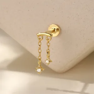 Detailed macro view of a gold starburst fringe cartilage stud with shimmering stones