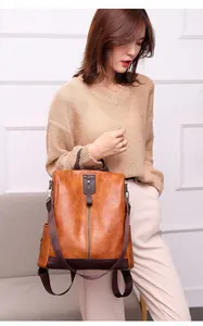 Stylish brown PU leather anti-theft backpack for women shown on model for daily use