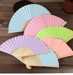 Macro detail of colorful DIY folding fans with blank paper surfaces and bamboo ribs