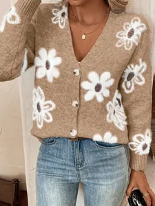 Detailansicht eines beigen Damen-Strickcardigans mit weißem Blumenmuster und V-Ausschnitt.