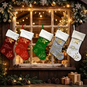 Set of five colorful embroidered Christmas stockings hanging on a rustic window sill.
