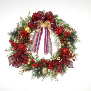 Close-up detail of festive Christmas wreath decorated with plaid bows pine cones and red berries