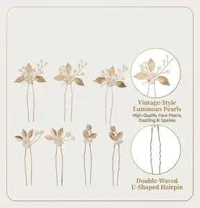 Close-up showing the elegant golden leaf and pearl details on a set of U-shaped hairpins