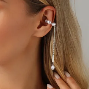Detailed view of elegant silver tassel ear cuff featuring delicate pearls worn on ear