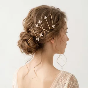 Elegant gold floral zirconia bobby pin set styled in a sophisticated bridal updo.