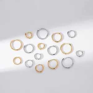 Detailed macro view of S925 sterling silver twisted rope hoop earrings in gold and silver