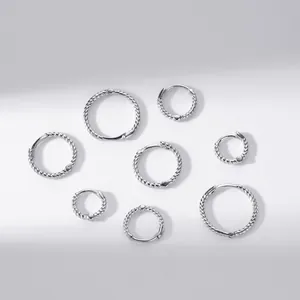 Macro detail of various S925 sterling silver twisted rope hoop earrings in multiple sizes