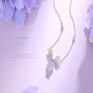 Elegant purple star necklace with silver bow pendant and violet gemstone details close-up