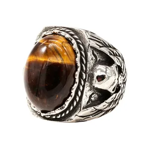 Vintage stainless steel ring featuring a tiger eye gemstone and intricate skull motifs