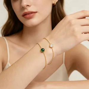 Close-up of elegant double-layered 18K gold-plated bracelets with gemstones