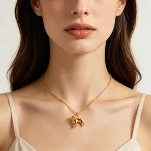 Close-up of an elegant 18K gold-plated necklace with a detailed dog-shaped pendant