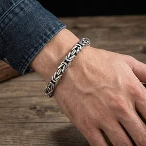 Détail d'un bracelet en acier inoxydable argenté de style byzantin sur poignet masculin