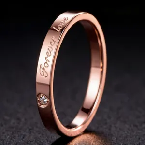 Rose gold titanium steel ring with forever love engraving and heart-shaped cubic zirconia.
