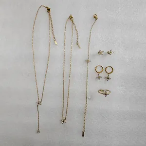 Full 18k gold plated jewelry set featuring delicate four-petal flower zircon charms.