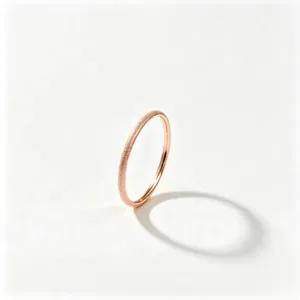 Detail view of a rose gold matte finish titanium steel ring with sparkling star texture.