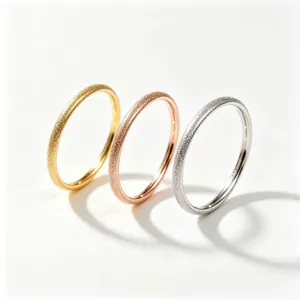 Close-up of frosted stainless steel rings in gold, rose gold, and silver finishes