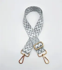 Adjustable jacquard bag strap with grey and white geometric diamond pattern view
