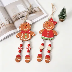 Detail of two wooden gingerbread man Christmas ornaments with dangling bead legs.