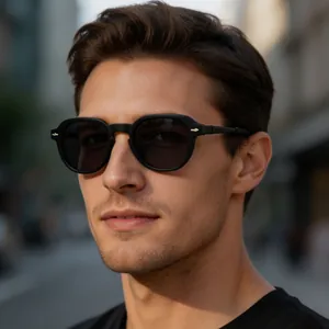 Close-up of a man wearing retro matte black square sunglasses in an outdoor street setting.