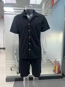 Front view of black textured short-sleeve shirt and shorts set on mannequin