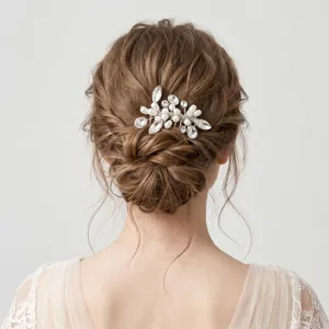 Elegant bridal bun hairstyle featuring a handmade pearl and crystal hair comb