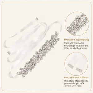 Detailed view of bridal white satin sash belt with sparkling rhinestone leaf clusters.
