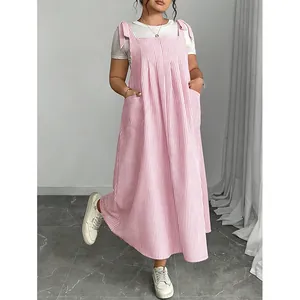 Close-up detail of plus size pink and white striped pinafore dress with bow shoulder straps