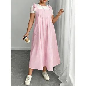 Detailed view of fashionable pink striped plus size pinafore dress with bow shoulder straps