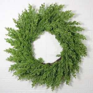 Lush green pine needle Christmas wreath with natural rattan base for front door decor