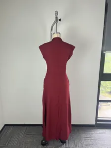 Rear view of an elegant burgundy stand collar dress with flutter sleeves on mannequin
