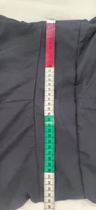 Close-up of navy flutter sleeve dress showing vertical length measurement with tape