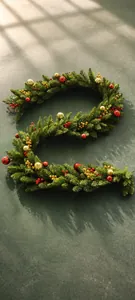 Detail view of 2.7m Christmas garland with red berries and ornaments